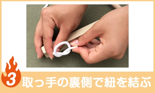 取っ手の裏側で紐を結ぶ